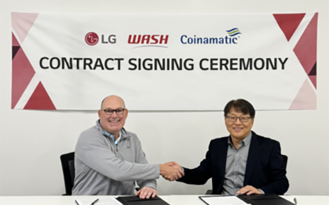 A photo of Jim Gimeson (CEO of WASH) and Sam Kim (Head of the Home Appliance Division at LG Electronics USA) shaking hands at the contract signing ceremony