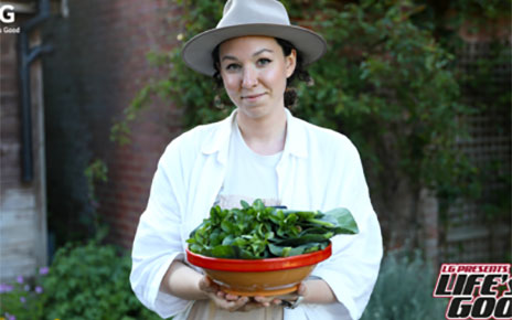 Immy posing with her homegrown vegetables which represent one of her ways of living sustainably. 