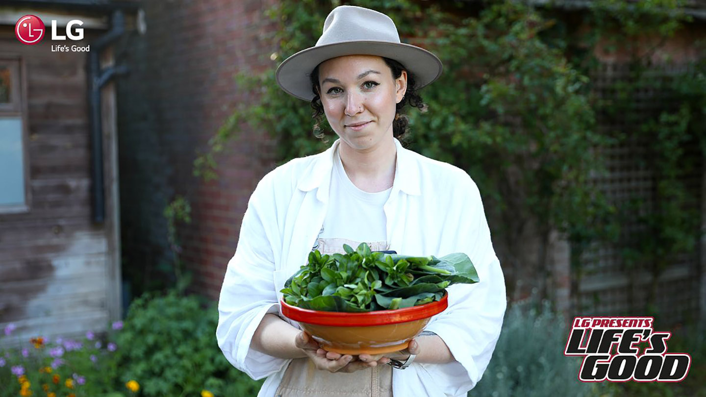 Immy posing with her homegrown vegetables which represent one of her ways of living sustainably. 