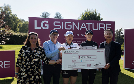 Justine Buisson, Franck Riboud, Ko Jin-young, Park Sung-hyun and Heaven Lee pose with a large check during the golf event to support online charity auction, 