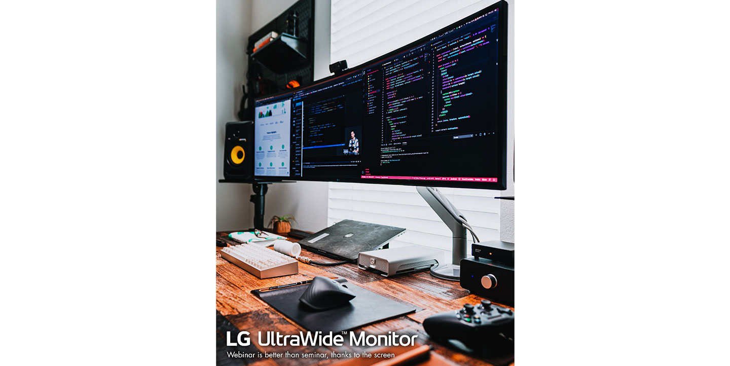 LG UltraWide Monitor with a 40-inch curved 21:9-aspect-ratio screen displaying various programs at once on a home desk.