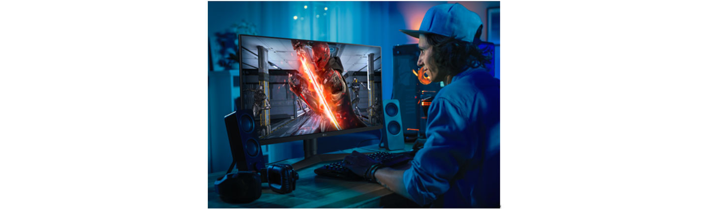 A gamer experiencing the high-speed, extremely sharp images provided by the LG UltraGear™ gaming monitor while playing an action video game at home.