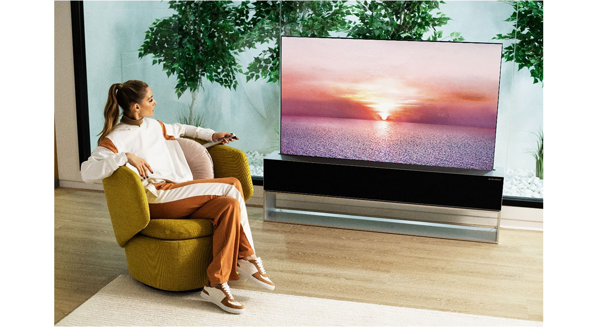 Olivia Palermo is watching the LG SIGNATURE OLED R TV, positioned in the living room.