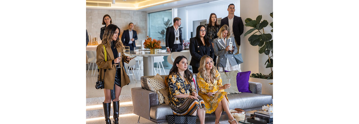 Guests watch on with a glass of wine as the new Wine Cellar and other LG SIGNATURE products are introduced to them