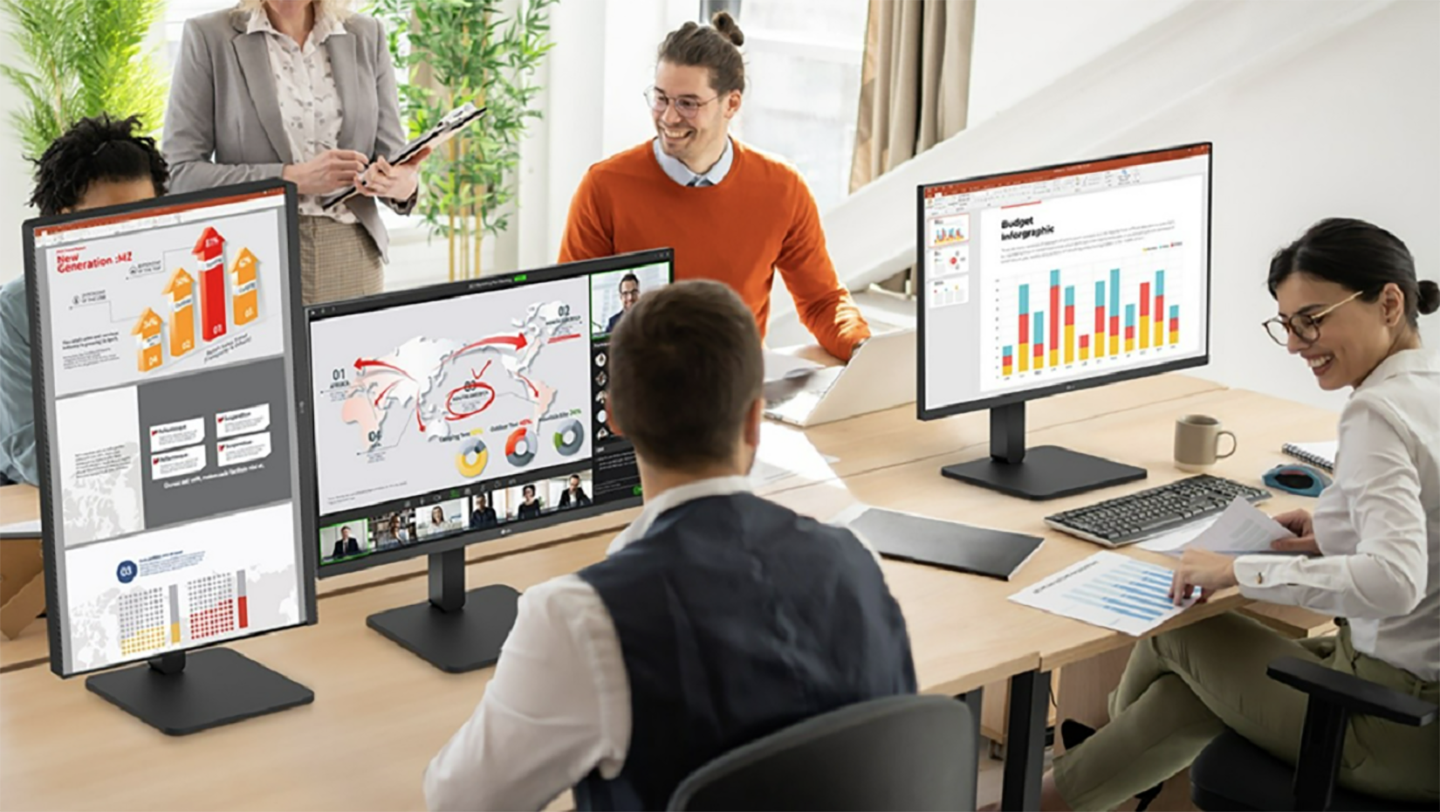 A picture of a group of people working together with different ergonomic monitors