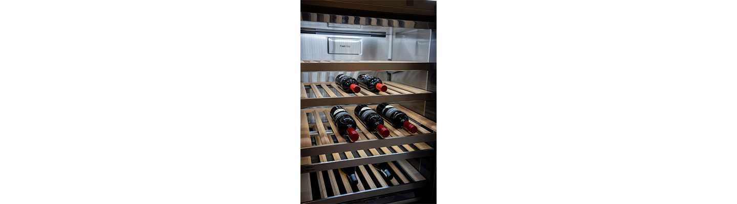 Inside of LG SIGNATURE Wine Cellar filled with a few bottles of wine