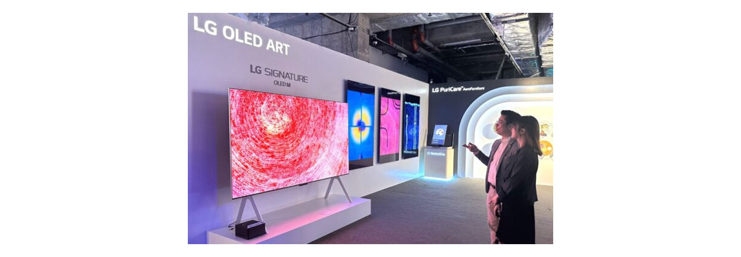 Visitors observe the LG SIGNATURE OLED M3 model displayed as part of the LG OLED Art booth at the Hong Kong Digital Art Fair