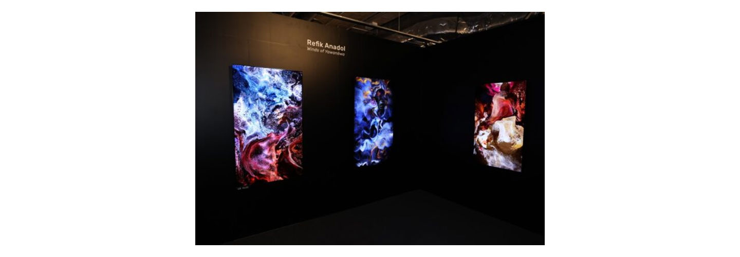 A booth at the Hong Kong Digital Art Fair featuring a digital representation of Refik Anadol's artwork on LG Smart TVs