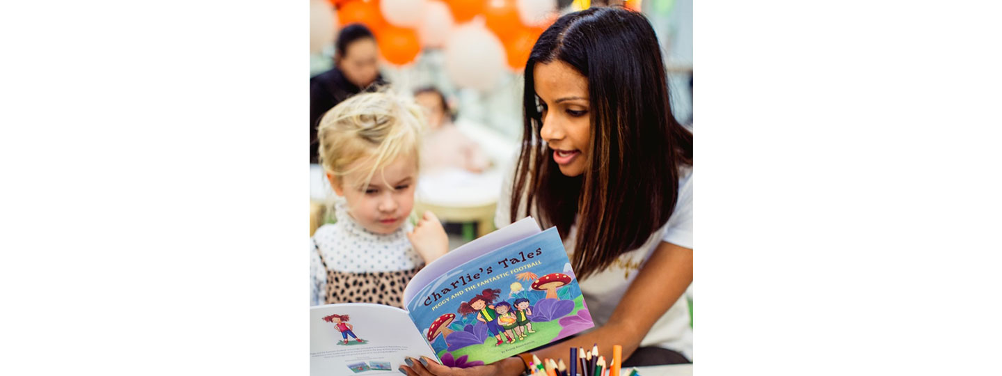 Merissa Forsyth, founder of the Pretty Foundation that encourages girls to feel better about their bodies, reading a book to a young girl.