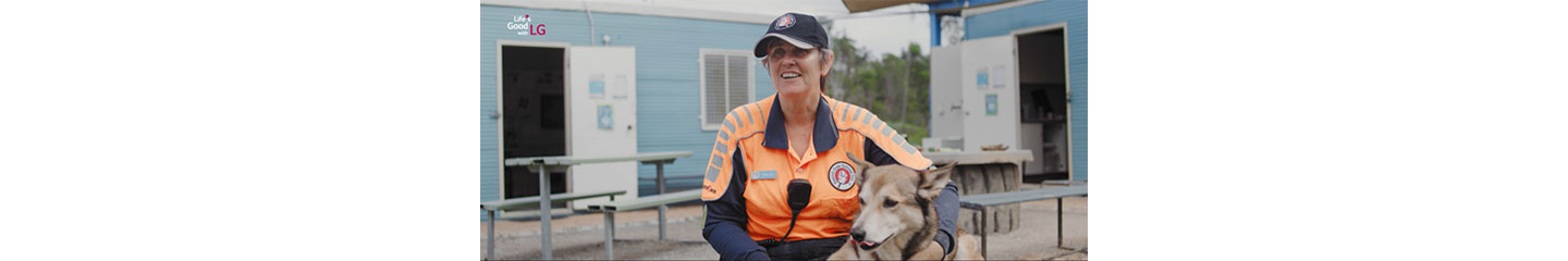 Adele Jago giving an interview about her work searching for missing people as a search dog sits on her lap.
