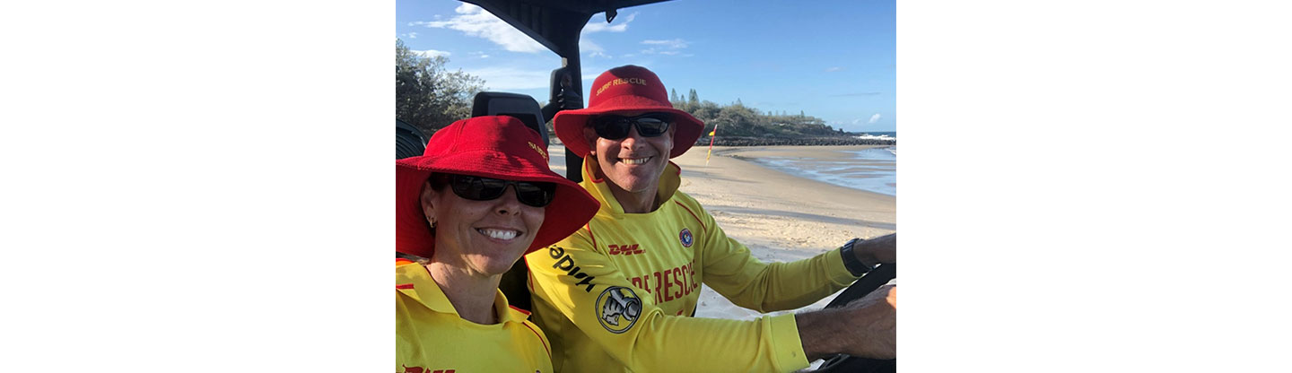 Scott Collins and a fellow member of Surf Life Saving Australia, the nation’s leading non-profit organization for coastal water safety, in full uniform while operating an emergency vehicle.