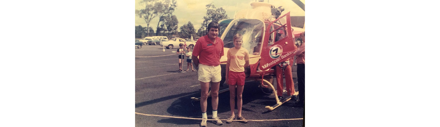  An old photo of Scott Collins and his father, who was also passionately involved in life-saving activities for over 40 years, posing in front of a helicopter.