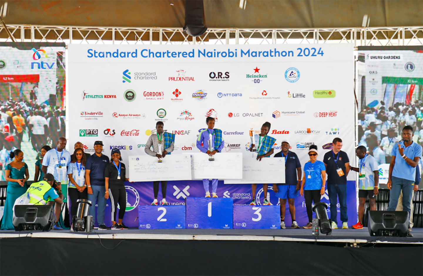 A photo of marathon winners at East Africa receiving their awards on the podium