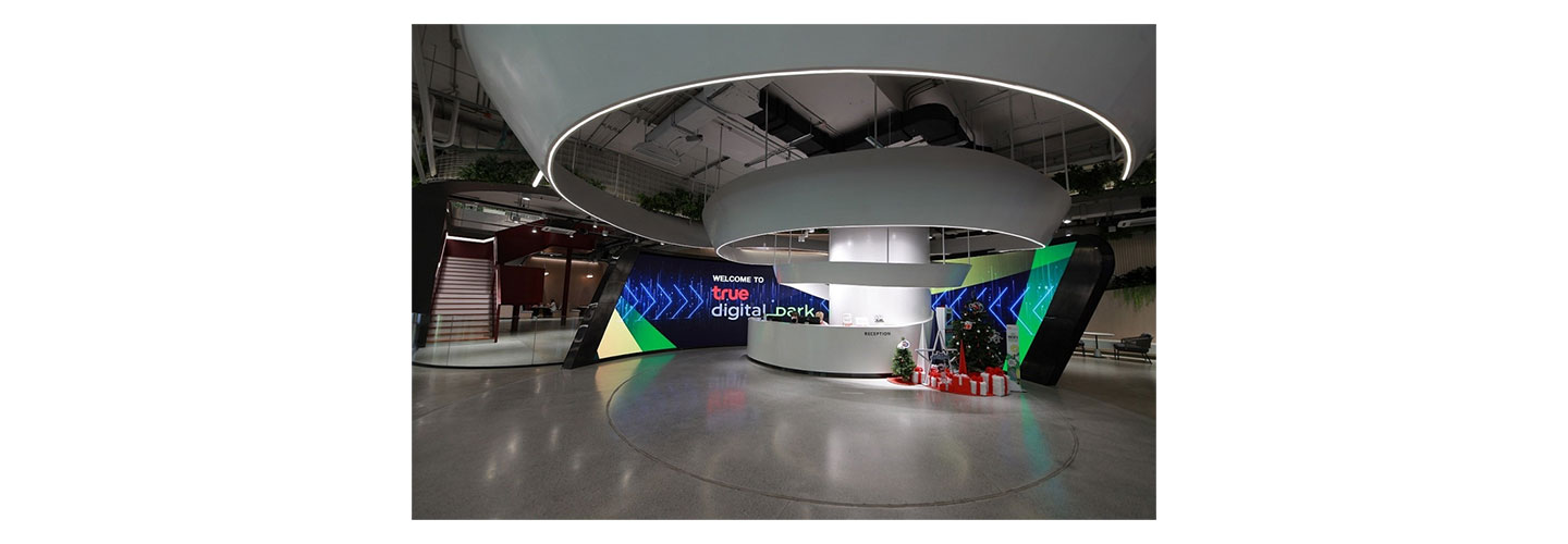 The information desk at True Digital Park West surrounded by a curved LG signage display.