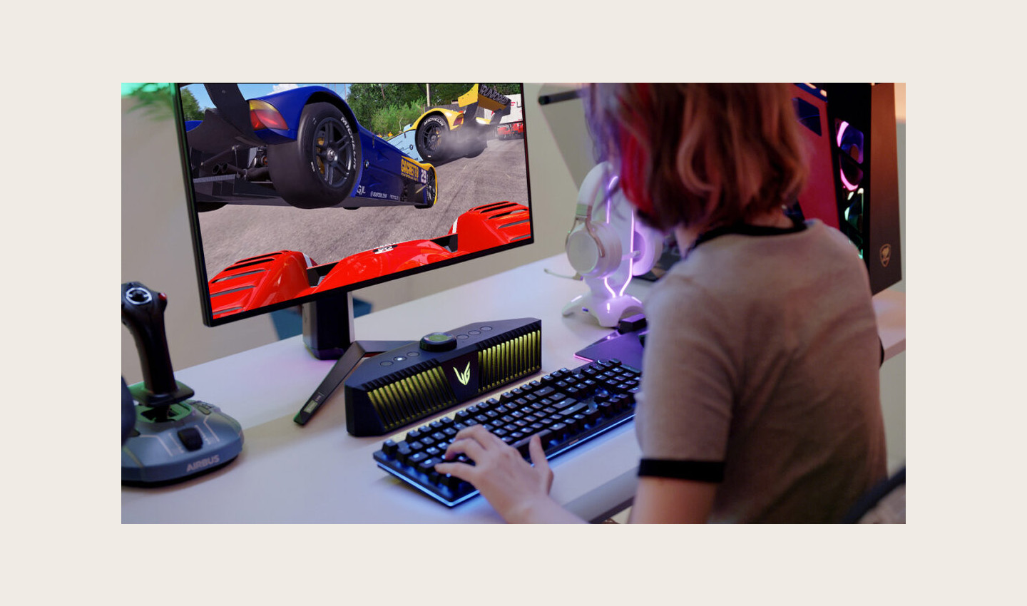 A gamer playing a game on an LG UltraGear gaming monitor with an LG UltraGear Gaming Speaker (model GP9) set up