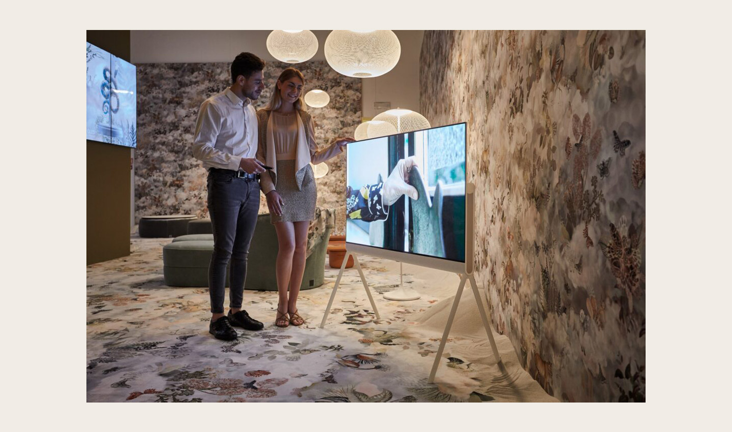 Two visitors taking a closer look at LG OLED Objet Collection, Posé (LX1), displayed at Salone dei Tessuti during Milan Design Week 2022LG Unleashing Latest Cutting-Edge Appliances and Solutions on Milan Design Week
