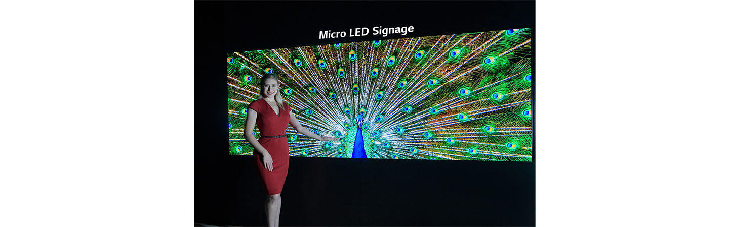 A model poses with the Micro LED signage.