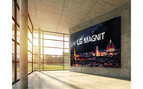 A modern interior space boasting natural light from its expansive windows has LG MAGNIT hanging on the wall, the new Micro LED signage solution displaying a beautiful, crystal-clear night scene of Italian city Florence