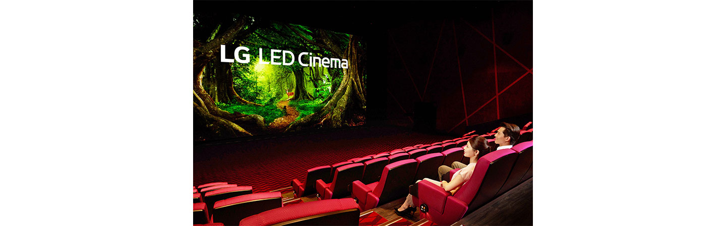 A woman and a man are looking at the LG LED Cinema Display as it produces a colorful nature scene at Showtime Cinemas, Taiwan's leading movie theater company