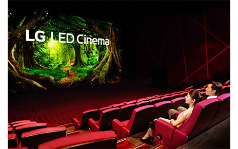A woman and a man are looking at the LG LED Cinema Display as it produces a colorful nature scene at Showtime Cinemas, Taiwan's leading movie theater company