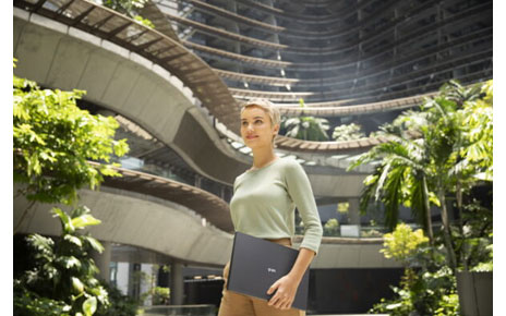 A woman is holding a LG gram laptop