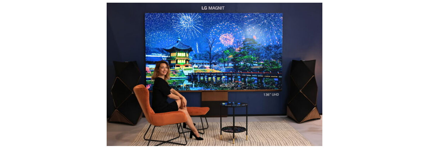LG MAGNIT and a woman sitting next to the display