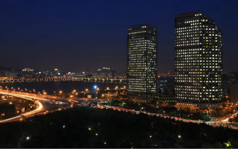 An aerial view displays a nighttime cityscape of the LG Twin Towers.