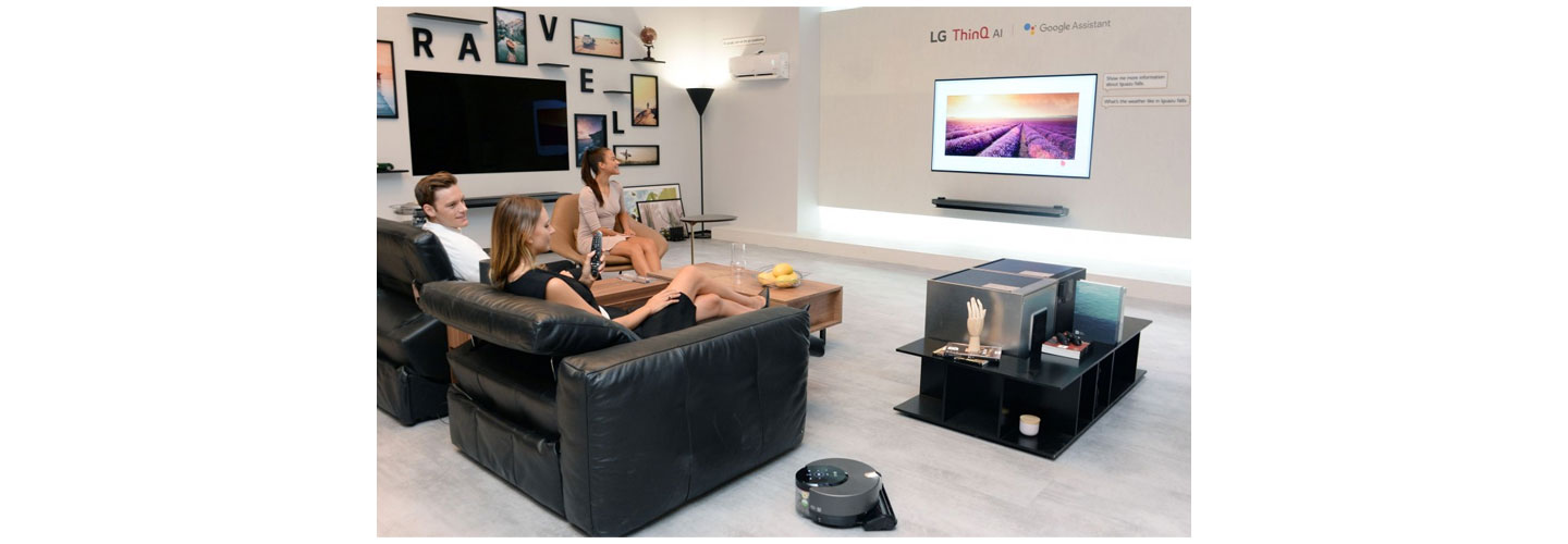 Models pose with LG ThinQ AI TV at the LG booth at IFA 2018.