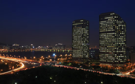 An aerial view displays a nighttime cityscape of the LG Twin Towers.