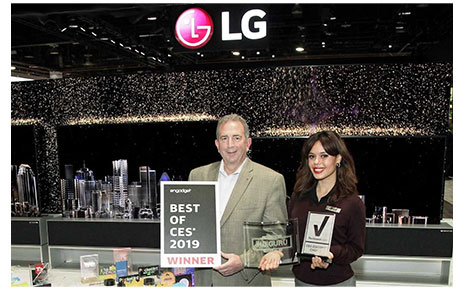 LG representatives pose with awards from Engadget, HD Guru and Reviewed.com