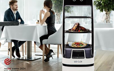 A picture of a woman and a man at a restaurant with the LG CLOi ServeBot next to them