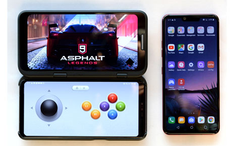 The front view of the LG V50 ThinQ 5G connected to the LG Dual Screen, with the Asphalt 9 Legends game on the top and LG Game Pad on the bottom, next to the LG G8 ThinQ