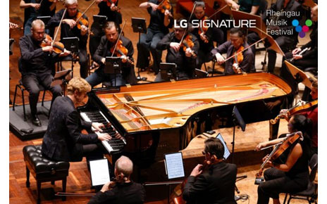 Pianist Jan Lisiecki performing with an orchestra at the Kurhaus Wiesbaden convention center for a charity concert LG SIGNATURE hosted