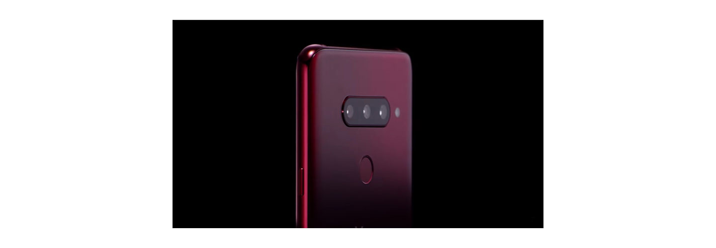 The top, rear half of the LG V40 ThinQ in Carmine Red, showing off the microscopic pits on the rear glass of the LG etched by employing the proprietary Silky Blast™ treatment