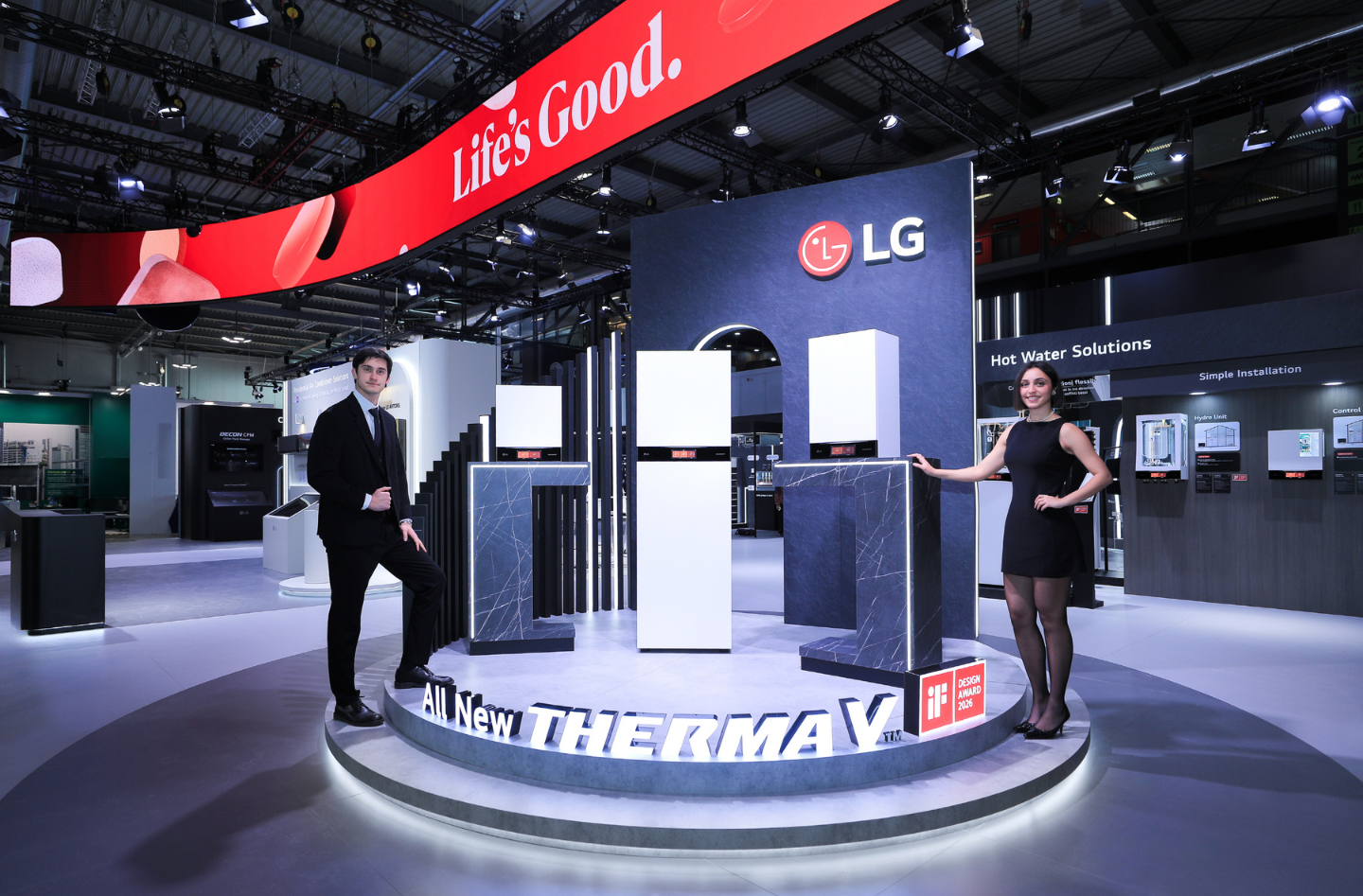 A man and a woman stand beside LG’s Therma V™ indoor units at the company’s booth during MCE 2026.