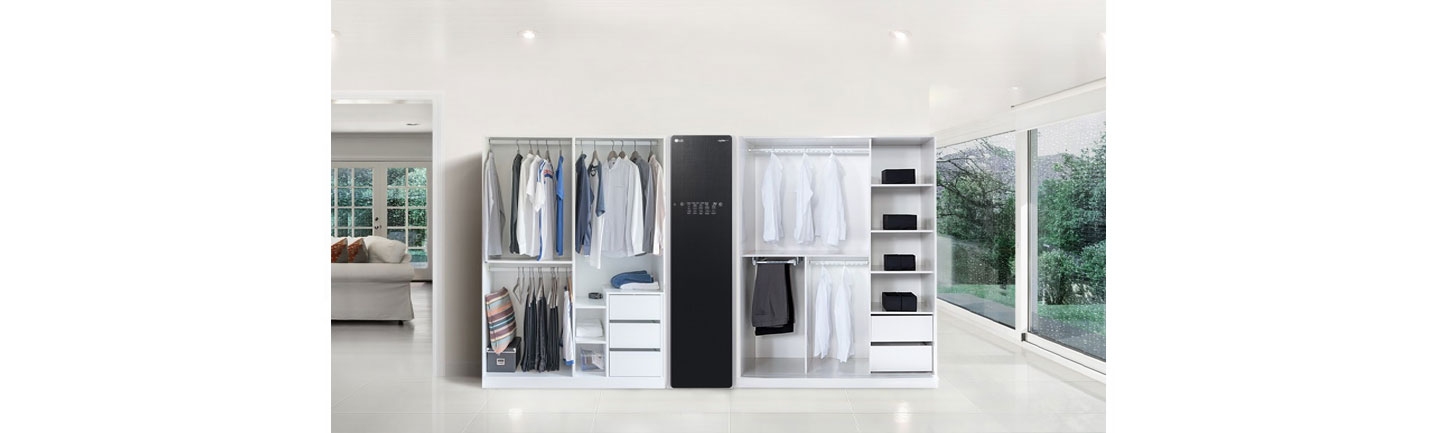 LG Styler with two doorless closests full of clothes on either side in a large living room