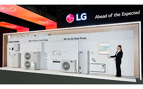 A photo of the LG Home Electrification Solutions Zone showcasing Energy Solutions, Air-to-Water Heat Pump, and Air-To-Air Heat Pump and a woman standing inside at AHR Expo 2024