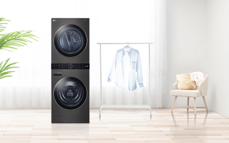 LG WashTower standing in a living room with a shirt on a hanger