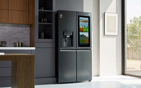 A kitchen with LG InstaView Door-in-Door refrigerator with UVnano showing its inside with InstaView becoming transparent