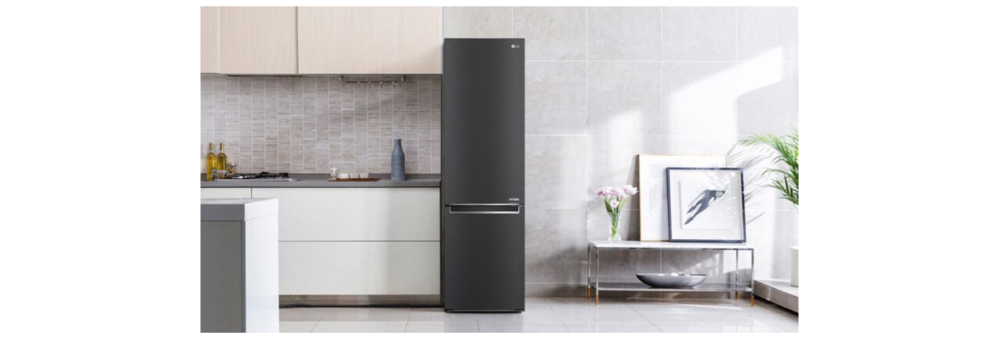 LG's new bottom freezer with top-tier energy efficiency is placed next to the kitchen drawers