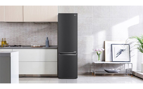 LG's new bottom freezer with top-tier energy efficiency is placed next to the kitchen drawers