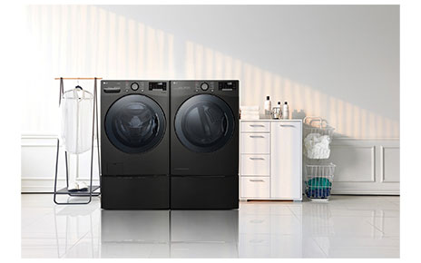 LG TWINWash™ washing machine and dryer in a laundry room