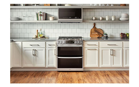 LG InstaView Double Oven Range and Over-the-Range Microwave Oven seamlessly harmonized in a bright kitchen.