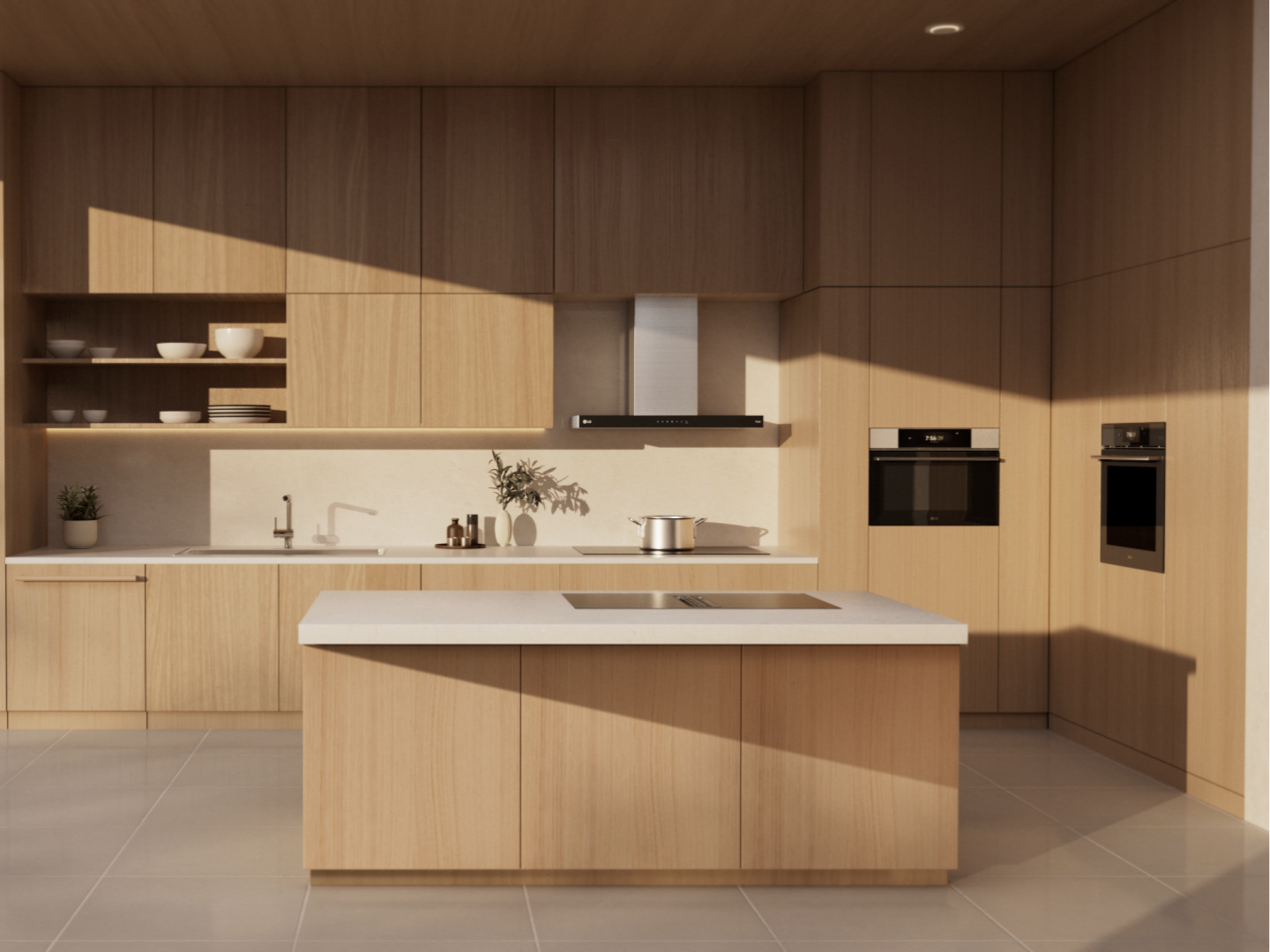 LG’s built-in full kitchen package, including a hood-integrated induction cooktop and ovens, is displayed in a minimalist kitchen setting with light wood cabinetry and an island countertop.