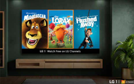 A wall-mounted LG smart TV in a cozy living room displays posters from newly added animated movies on LG 1, including Madagascar, The Lorax and Flushed Away