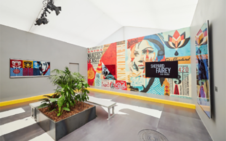 Two LG OLED TVs are positioned above a mural, with the right displaying Shephard Fairey X LG OLED and the left displaying part of the mural