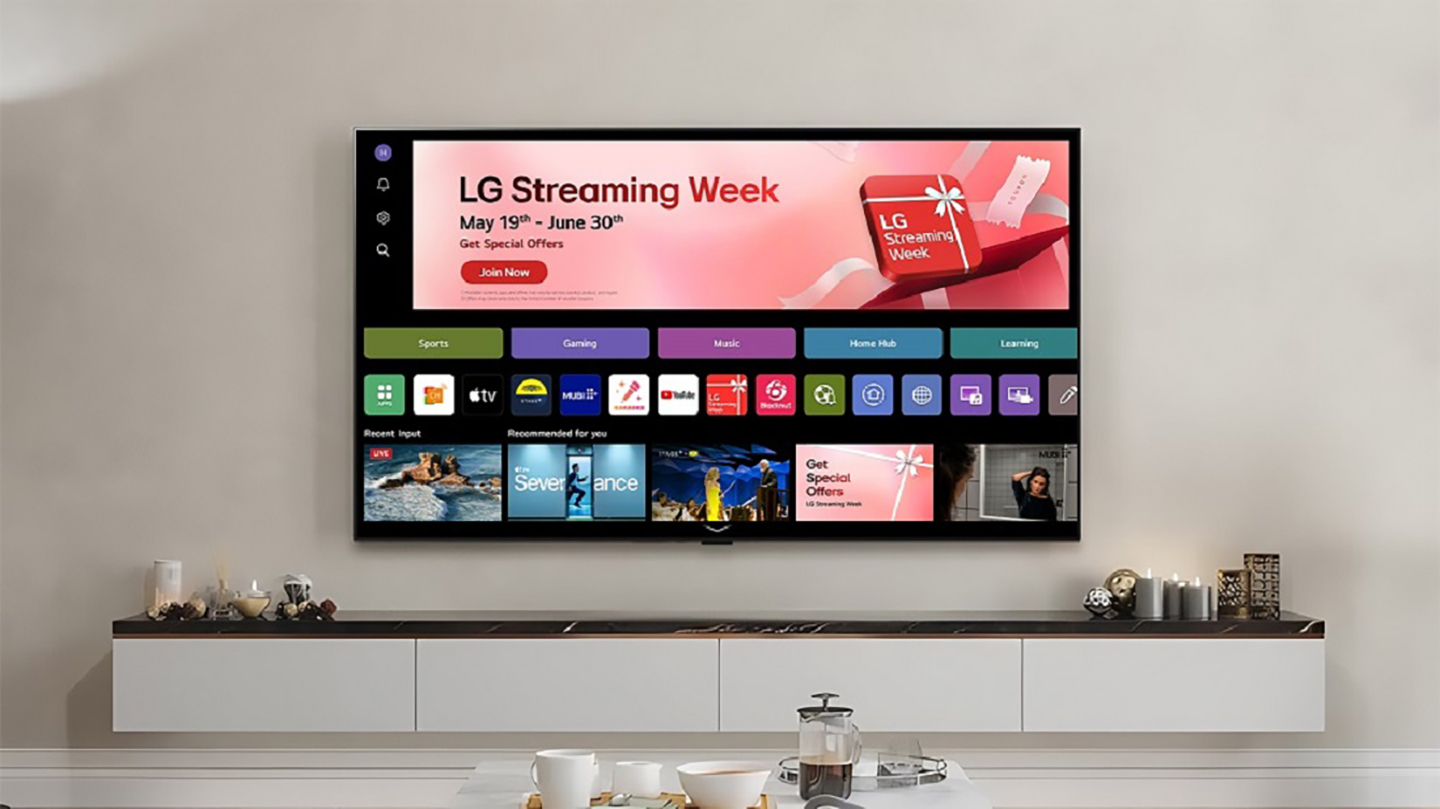 A wall-mounted LG Smart TV showcases the 'LG Streaming Week' promotion on its home screen in a modern living room.