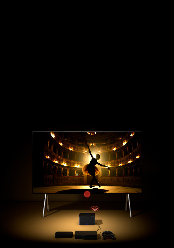LG SIGNATURE OLED M4 from a high angle in a dark space illuminated by a spotlight, with multiple consoles and devices connected to it by wires that look messy before fading away. Zero Connect Box fades in with neatly organised devices and consoles behind it, a red Wi-Fi signal appears and a red beam emits towards the TV as the perspective swings down to show a full view of the TV.