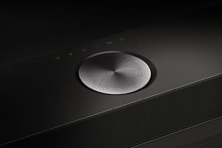 Close-up of one of the speakers on an LG Soundbar. The Soundbar controls are seen above the speaker. 	