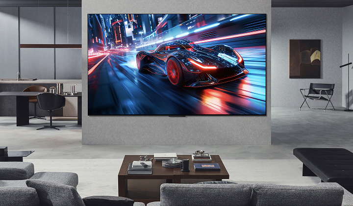 Living room with a huge LG Ultra Big TV mounted on the wall. On the screen is a car racing game. Because of the screen size, the content feels so much more immersive.